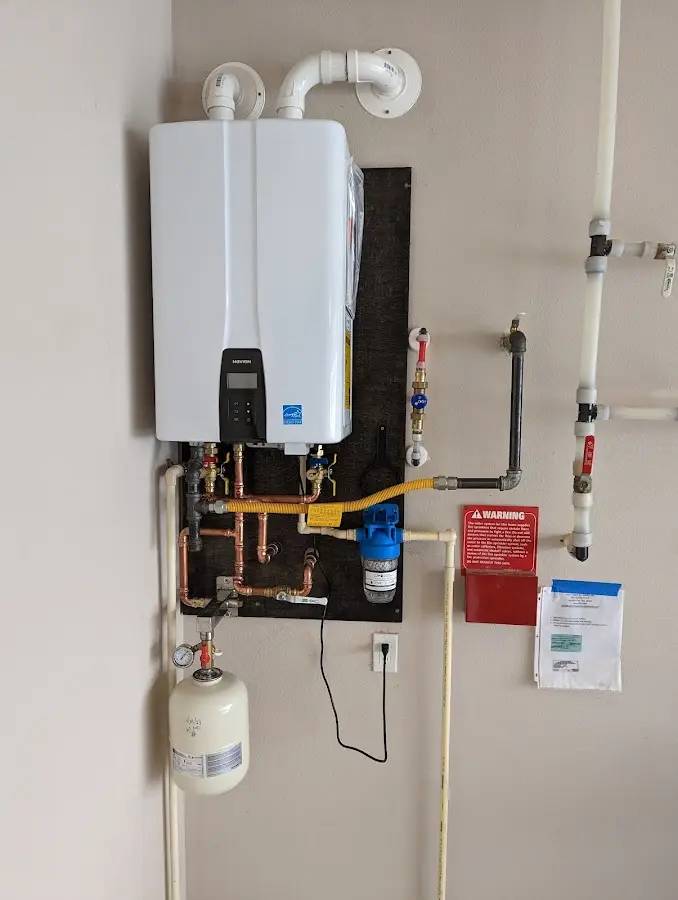 Professional plumber installing copper piping in a Masontown home